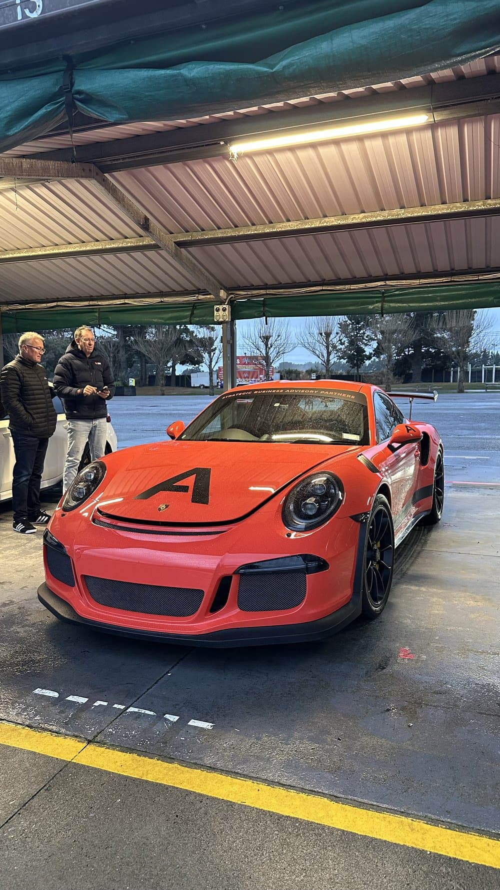 The Advisry race car in the pits at a track day